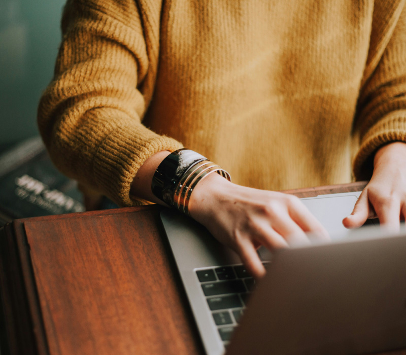 a photo of someone using their laptop at their desk